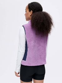 Back view of Candy Fleece Vest in Lavender, featuring contrast nylon side panels and a mock neck.