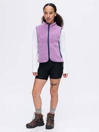 Model wearing Candy Fleece Vest in Lavender, featuring contrast nylon side panels and two front zipper pockets.