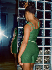 Model from the back wearing CloudKnit 3.5" Short in Green with adjustable straps and tailored waistband.
