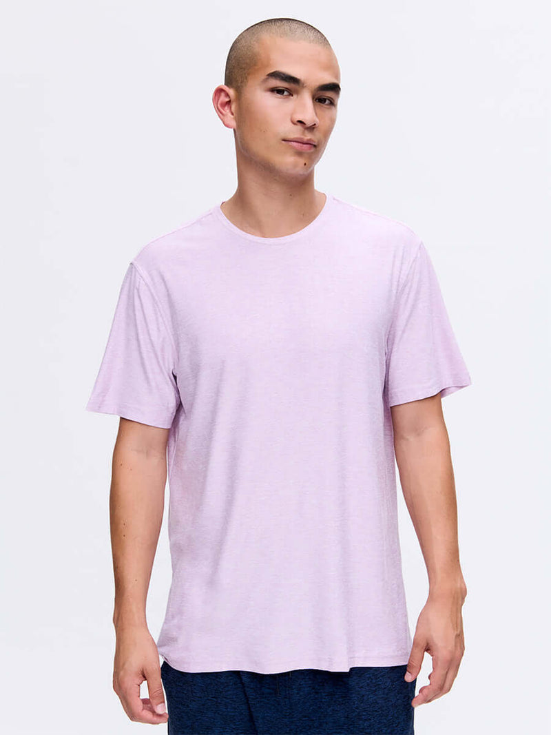 Model standing in a relaxed pose wearing CloudKnit Shortsleeve in Light Purple, soft and breathable fabric.