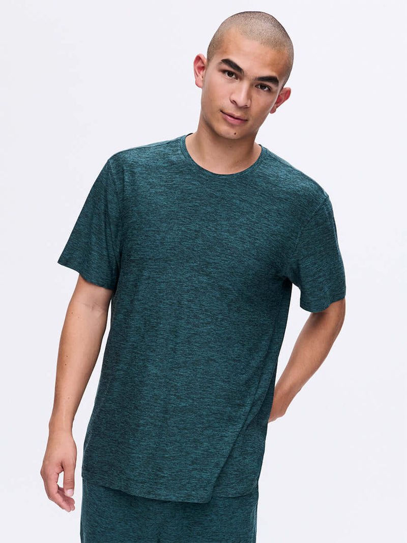 Model standing in CloudKnit Shortsleeve in Deep Teal, featuring soft breathable fabric for everyday wear.