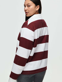 Back view of a model wearing the Club Polo, featuring maroon and white stripes, for fall layering.