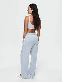 Model from the back wearing Desert Pant in light blue, with the wide-leg style and elastic waistband.