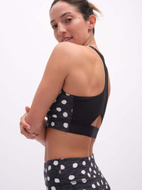 Back view of Doing Things Bra in Black with mesh backing and polka dot design, ideal for performance activities.
