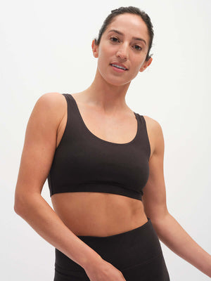 Model wearing Double Dip Bra in Black with wide shoulder straps for comfortable everyday support.