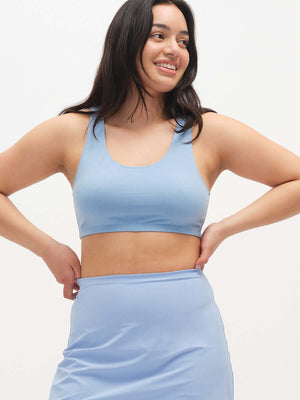 Model smiling in Double Dip Bra in Cotton Candy, featuring a double scoop neckline and wide shoulder straps.