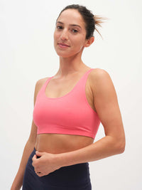 Model wearing Double Dip Bra in Cotton Candy, featuring a double scoop neckline and wide shoulder straps.