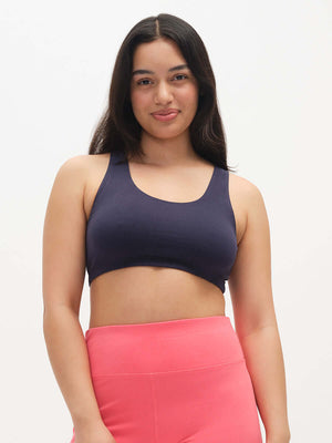 Model wearing Double Dip Bra in Navy, featuring a double scoop neckline and wide shoulder straps.
