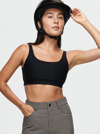 Model wearing Double Time Bra in Black, featuring a double scoop design and medium support for activewear.