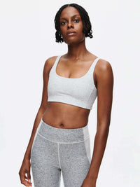 Model wearing Double Time Bra in Light Grey, featuring a double scoop design for medium support.