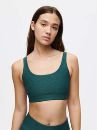 Model wearing Double Time Bra in Deep Teal, featuring a double scoop neckline and medium support for activewear.