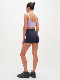 Back view of Echo 3.5" Short in Cotton Candy with tall waistband, paired with lavender sports bra.