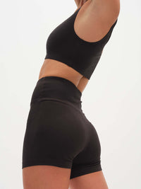 Model wearing Echo 3.5" Short in Black, featuring a tall waistband for a secure fit.