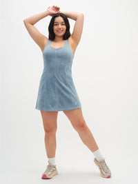 Model posing in Energy Dress in soft blue, featuring a relaxed A-line silhouette and built-in shelf bra.