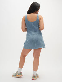 Model from the back in Energy Dress, light denim A-line silhouette, for casual outings.