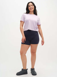Model in relaxed pose wearing Everyday Shortsleeve in Lavender, slight crop with relaxed fit, styled for everyday wear.