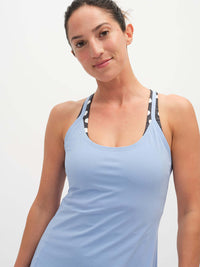Model wearing The Exercise Dress in Light Blue with adjustable straps, styled for everyday activities.