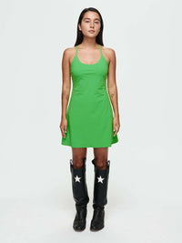 Model with The Exercise Dress in vibrant green, for any activity with adjustable straps and built-in shorts.