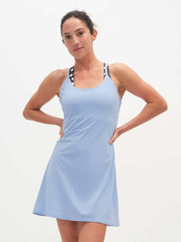 Model posing in The Exercise Dress in Light Blue, featuring adjustable straps for comfort during workouts.