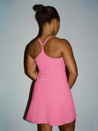 Back view of The Exercise Dress in Pink with adjustable straps and swingy silhouette, ideal for active days.