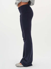 Side view of Flared Legging in Navy, featuring an extra-tall waistband for customizable fit.