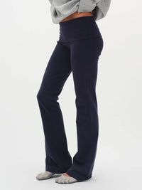 Side view of Flared Legging in Navy, featuring an extra-tall waistband for customizable fit.