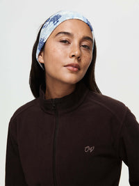 Model wearing Frosted Headband in Blue with exclusive Elf Garden print for warmth and style.