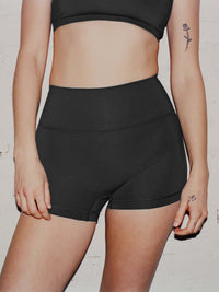 Model wearing Gemini High Rise Short in Black, featuring a wide waistband for support.