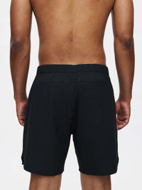 Back view of High Stride 7" Short with Pockets in Black, featuring a stretchy waistband and pockets.