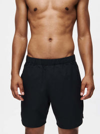 Model wearing High Stride 7" Short with Pockets in Black, featuring an elastic waistband and lightweight fabric.