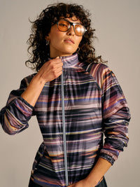 Model posing in Jog Jacket with colorful stripes, featuring a full zip and elasticated cuffs, for daily activities.