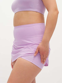 Side view of LightSpeed Minimal 3" Skort in Lavender, featuring a smooth fabric and built-in shorts liner.