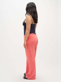 Side view of model wearing Malibu Sweatpant in Pink, featuring wide leg design and elastic waistband for comfort.