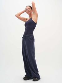 Model posing in Malibu Sweatpant in Navy, featuring a relaxed wide leg and elastic waistband.