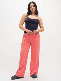 Model standing in pink Malibu Sweatpant with wide legs and elastic waistband, styled for lounging.