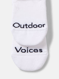 Flat lay of OV No Show Sock in White, featuring Outdoor Voices embroidery on the sides.