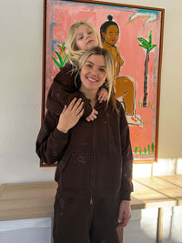 Woman with child wearing Sunny Sweatpant in Brown, styled for cozy lounging at home.