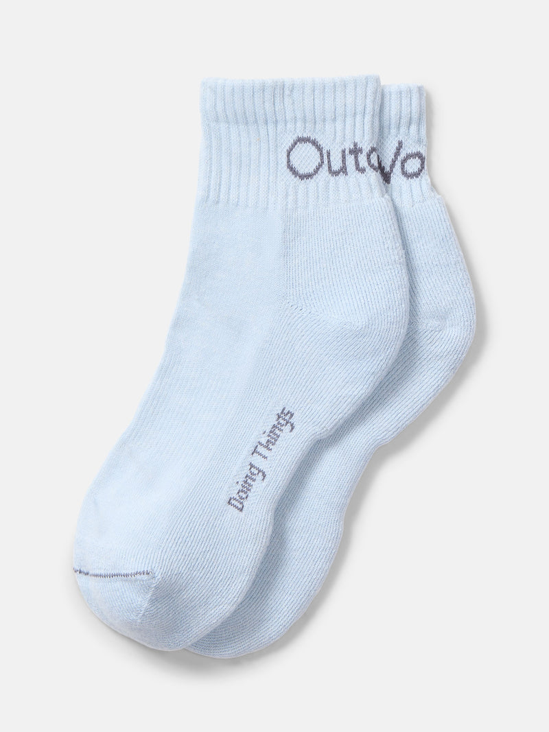 Flat lay of OV Rec Ankle Sock in light blue featuring a soft knit material and ribbed cuff.