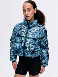 Model wearing Rainy Floral Puff in blue print, featuring a high collar and puffy silhouette.