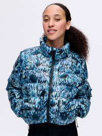 Model wearing Rainy Floral Puff in Blue, featuring a high collar and textured puffer design.