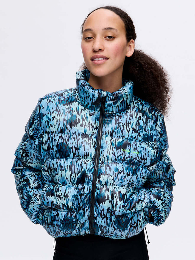 Model wearing Rainy Floral Puff in Blue, featuring a high collar and textured puffer design.