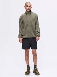 Model standing in RecFleece 1/2 Zip in Olive, featuring a front half zip and relaxed fit.