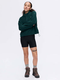 Model wearing RecFleece 1/4 Zip in Deep Green, styled with adjustable hem and relaxed fit for climbing.