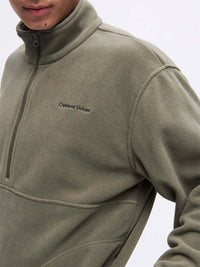 Model wearing RecFleece 1/2 Zip in Olive, featuring a soft fleece fabric and a front ½ zip.