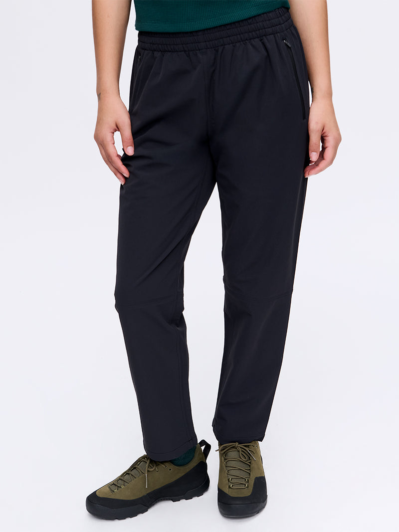 Model standing in RecTrek 26" Pant in black, featuring a comfortable elastic waistband and front pockets.