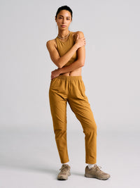 Model posing in RecTrek 26" Pant in Mustard, with the comfortable water-repellent fabric.