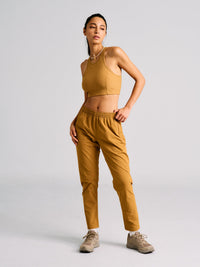 Model posing in RecTrek 26" Pant in Amber, featuring an internal drawstring and two side pockets.