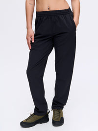 Model posing in RecTrek 29" Pant in Black, featuring a custom-fit drawstring and lightweight fabric.