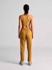 Back view of model wearing RecTrek 26" Pant in Golden Brown, featuring an internal drawstring for fit.