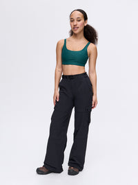 Model standing in RecTrek Cargo Pant in Black, featuring cinchable hems and four utility pockets.